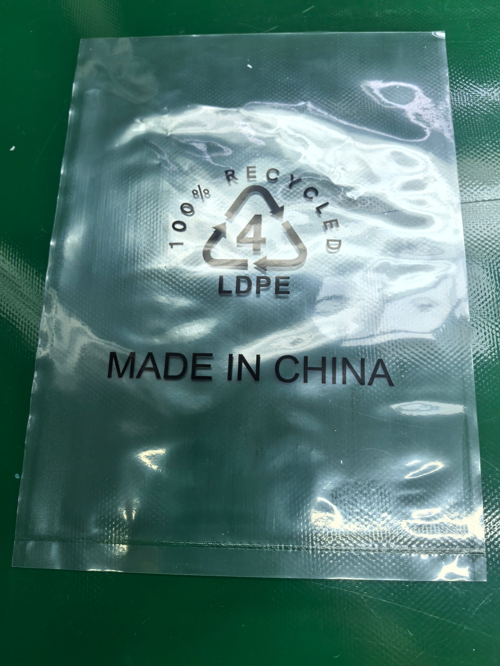 Our 100% recycled LDPE packing bag holding a finished product. The product itself is marked MADE IN CHINA; the transparent bag shows the item without extra packaging bulk.