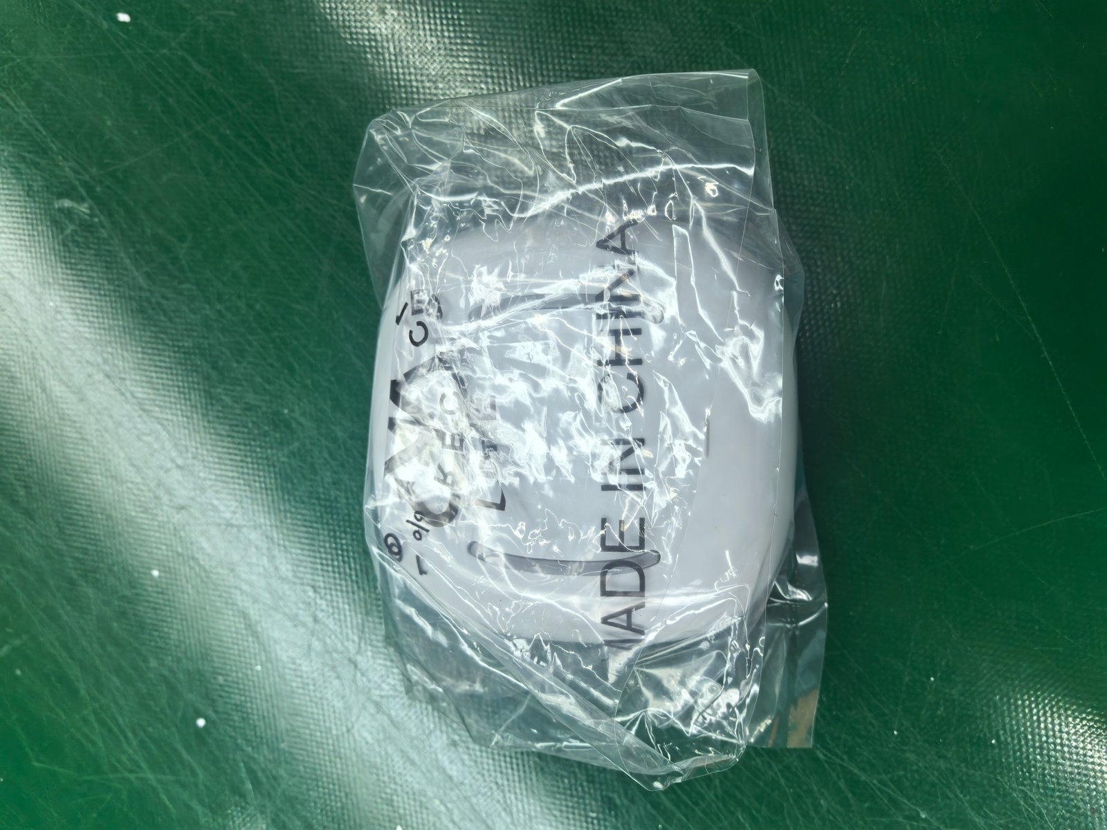 Close-up of the same packing bag, printed with 100% RECYCLED, resin code 4 (LDPE), and MADE IN CHINA. The resin code identifies low-density polyethylene, a standard recycled packaging material.